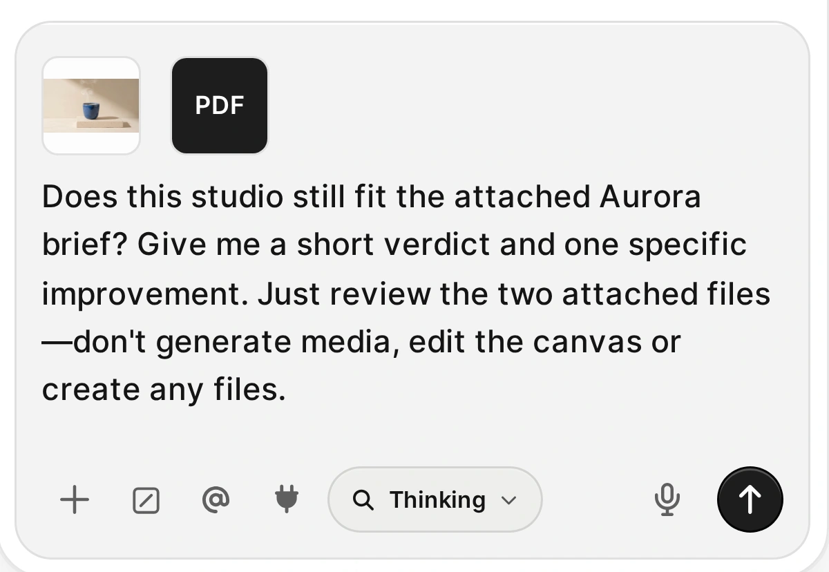 Agent composer with a blue-cup image, PDF attachment icon, and a request to check the studio still against the Aurora brief without making new media.